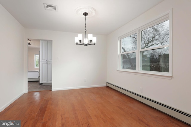 unfurnished dining area with a baseboard radiator, baseboards, visible vents, and light wood finished floors