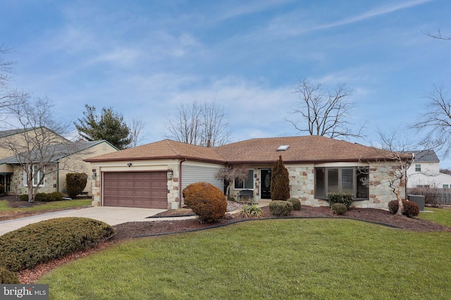 ranch-style home with stone siding, a front lawn, driveway, and central air condition unit