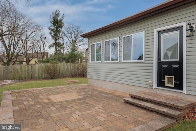 view of patio featuring entry steps and fence