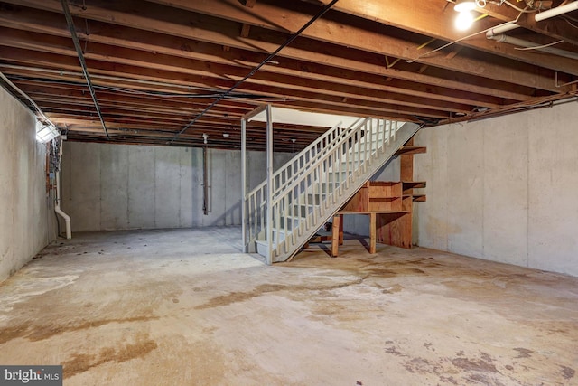 unfinished below grade area featuring stairs