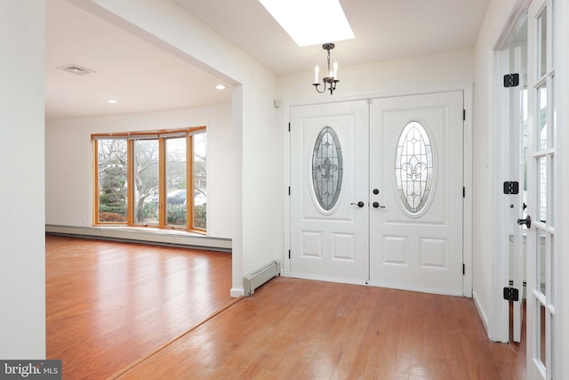 foyer with a baseboard heating unit, light wood-type flooring, french doors, and recessed lighting