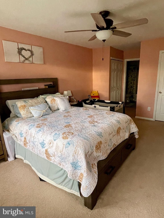 bedroom with ceiling fan, carpet floors, and baseboards