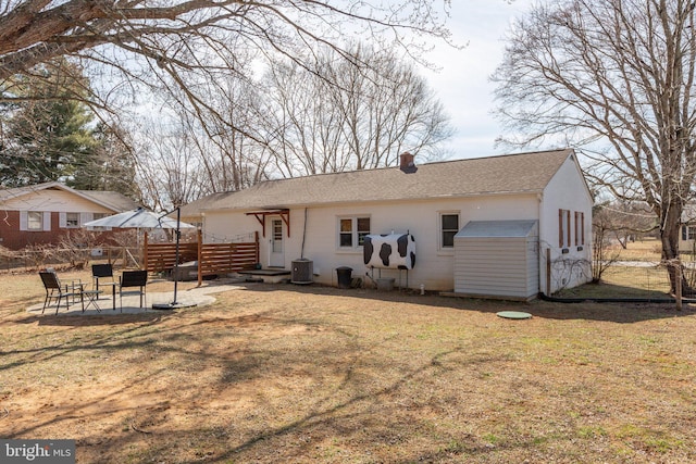 back of house with a yard, a chimney, a patio area, fence, and cooling unit