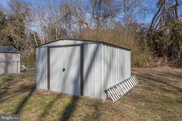 view of shed featuring fence