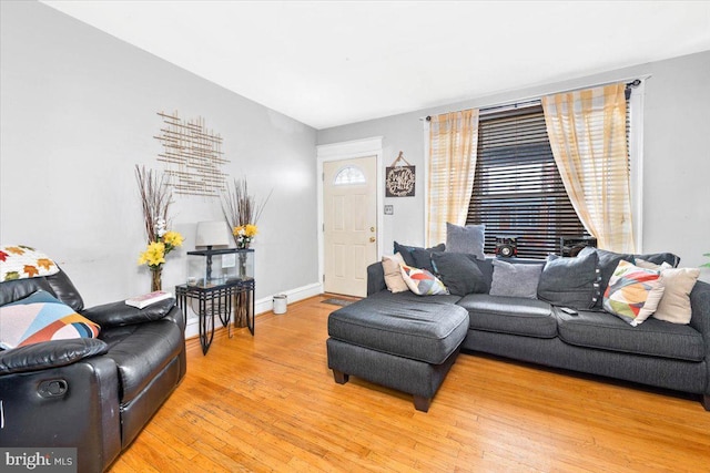 living area featuring wood-type flooring and baseboards