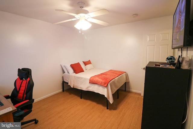 bedroom with baseboards, ceiling fan, and light wood finished floors