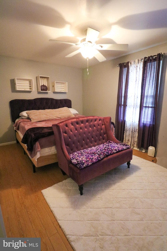 bedroom featuring hardwood / wood-style floors and a ceiling fan