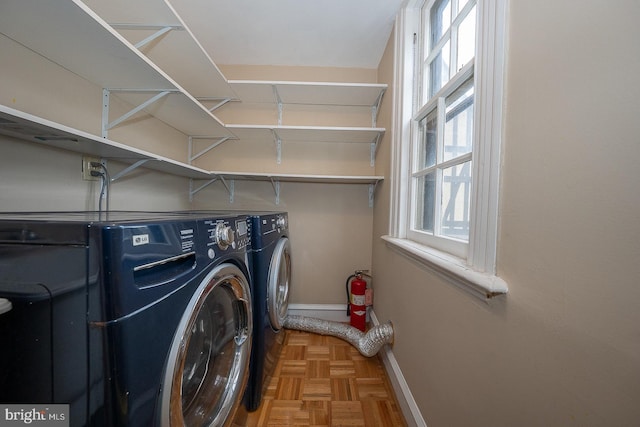 laundry room with laundry area, baseboards, and washing machine and clothes dryer