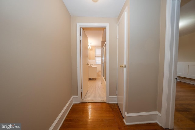 hall with wood finished floors