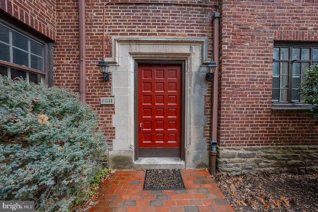 entrance to property with brick siding