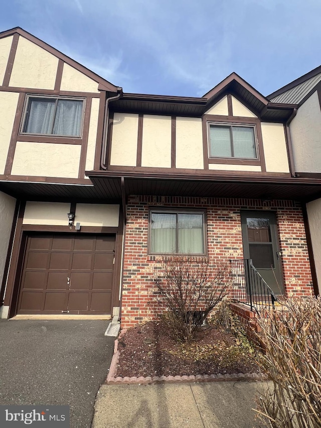 view of front of house featuring brick siding and stucco siding