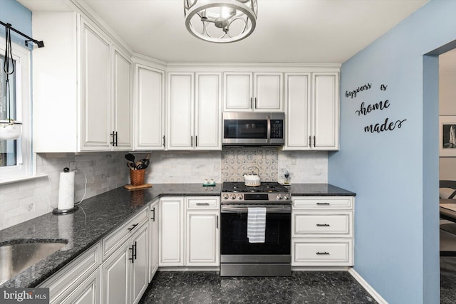 kitchen featuring stainless steel appliances, backsplash, white cabinetry, and baseboards