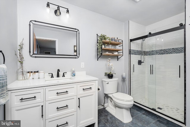 bathroom with a stall shower, vanity, toilet, and baseboards