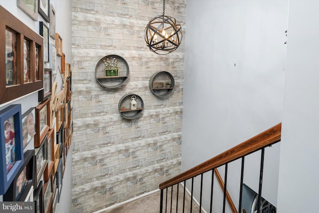 interior space featuring wood walls and a notable chandelier