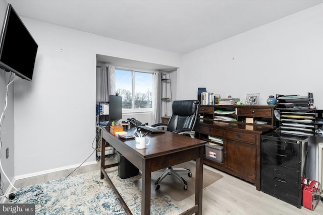 office area featuring light wood-style flooring and baseboards