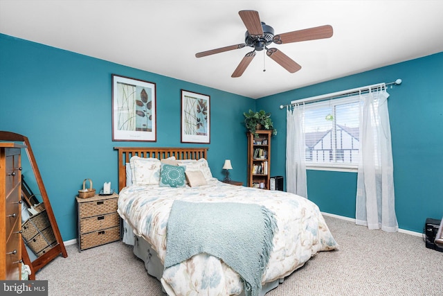 carpeted bedroom with a ceiling fan and baseboards