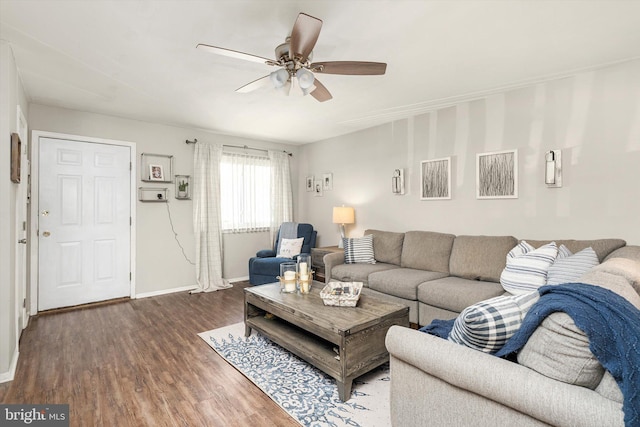 living area featuring ceiling fan, baseboards, and wood finished floors