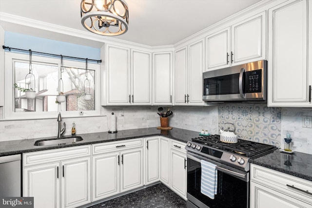 kitchen with backsplash, appliances with stainless steel finishes, white cabinets, and a sink