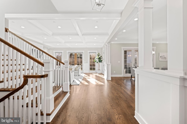 foyer entrance with dark wood-style floors, decorative columns, coffered ceiling, and beam ceiling