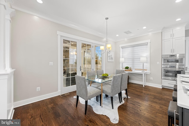 dining area with ornamental molding, dark wood-style flooring, and visible vents