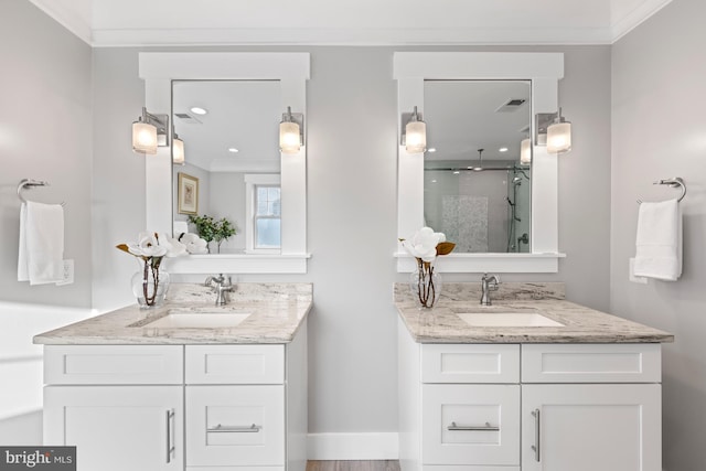 bathroom featuring a stall shower, two vanities, a sink, and visible vents