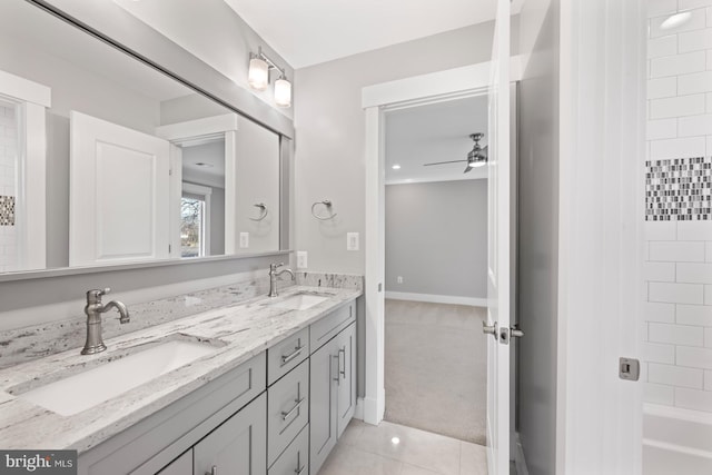 bathroom featuring a ceiling fan, tile patterned flooring, a sink, and double vanity