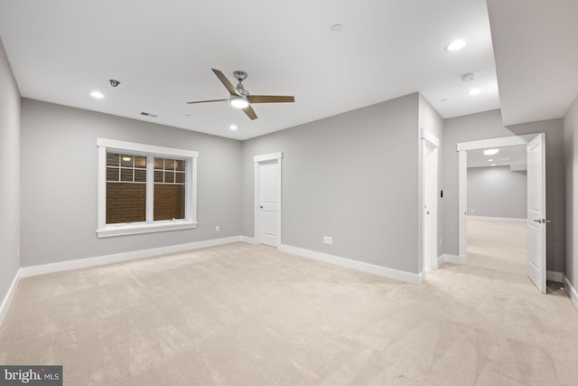 unfurnished room with light carpet, recessed lighting, visible vents, and baseboards