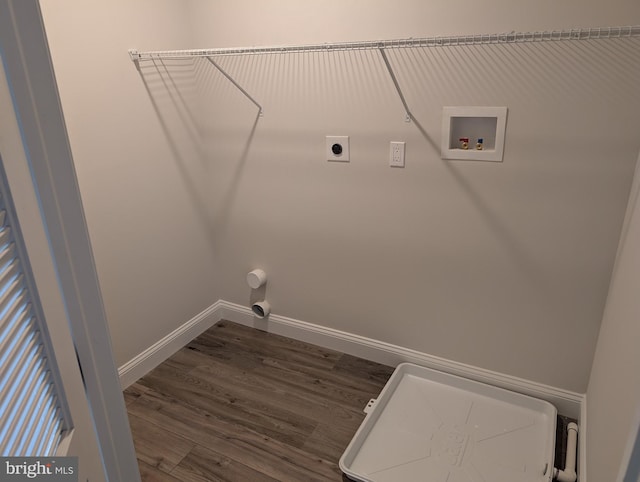 clothes washing area with electric dryer hookup, dark wood finished floors, laundry area, baseboards, and hookup for a washing machine