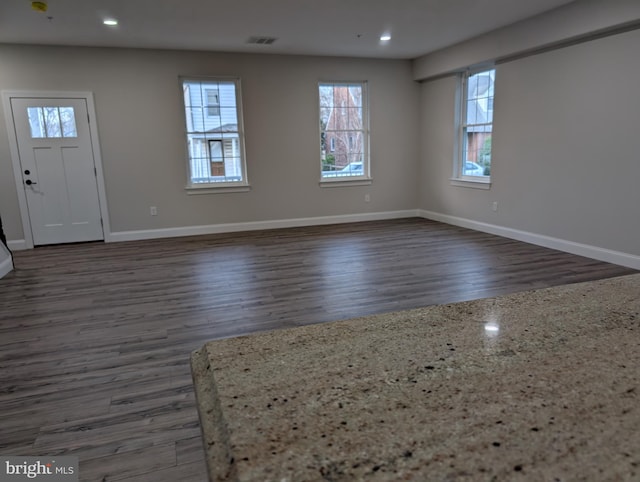 entrance foyer featuring baseboards, visible vents, wood finished floors, and recessed lighting