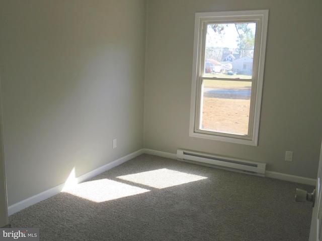 empty room with carpet floors, a baseboard radiator, and baseboards