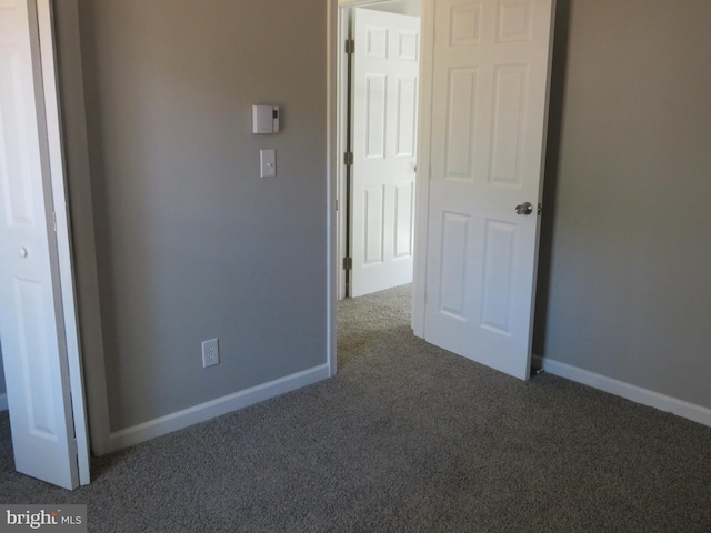 unfurnished bedroom with carpet and baseboards