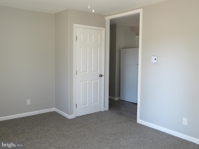 unfurnished bedroom with carpet and baseboards