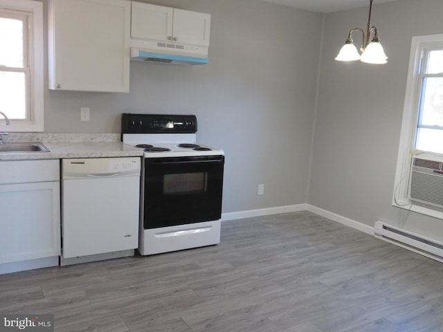 kitchen with white cabinets, electric range oven, white dishwasher, under cabinet range hood, and a sink