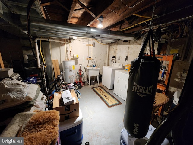 unfinished below grade area featuring electric water heater, a sink, and independent washer and dryer