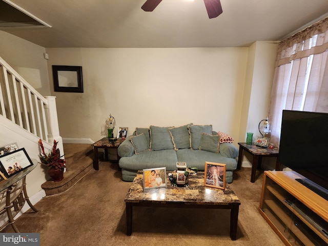 carpeted living room featuring a ceiling fan, stairway, and baseboards