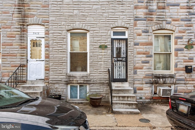 entrance to property featuring stone siding