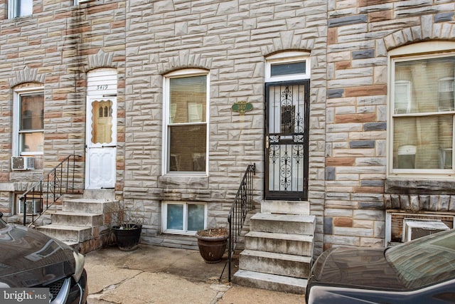 doorway to property featuring stone siding