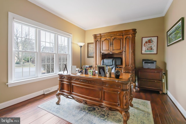 office space with dark wood-type flooring, visible vents, ornamental molding, and baseboards