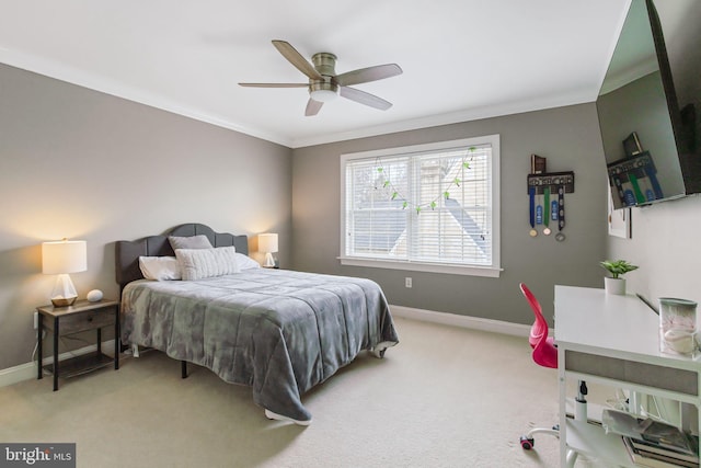 bedroom with ornamental molding, light carpet, ceiling fan, and baseboards