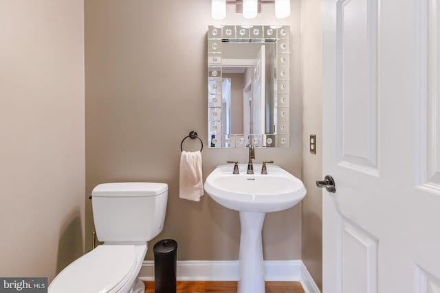 bathroom with toilet and baseboards