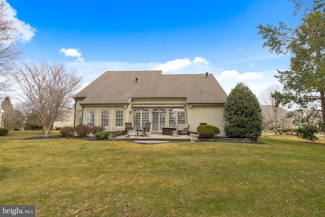 back of house with a patio, a shingled roof, a lawn, and stucco siding