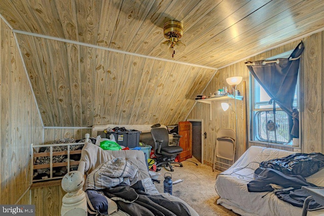 bedroom with lofted ceiling, wooden walls, wood ceiling, and carpet floors