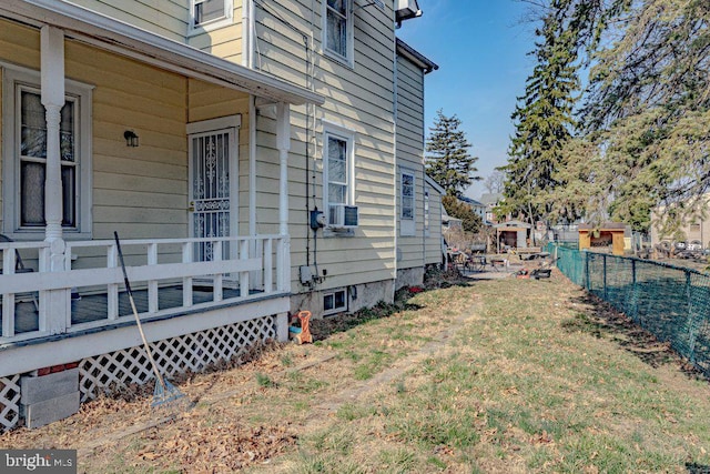 view of side of property featuring a yard and fence