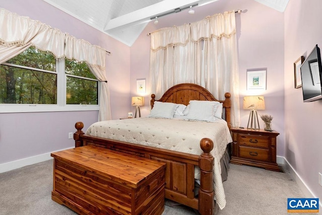 carpeted bedroom with vaulted ceiling and baseboards