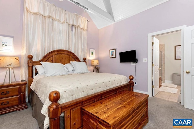 bedroom featuring carpet floors, ensuite bath, baseboards, and vaulted ceiling