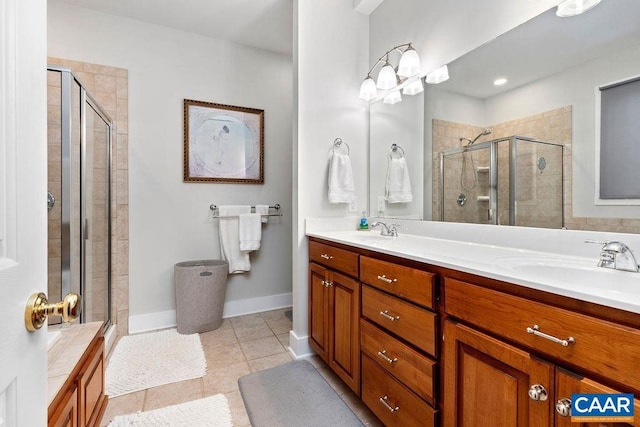 bathroom featuring tile patterned floors, a sink, a shower stall, and double vanity