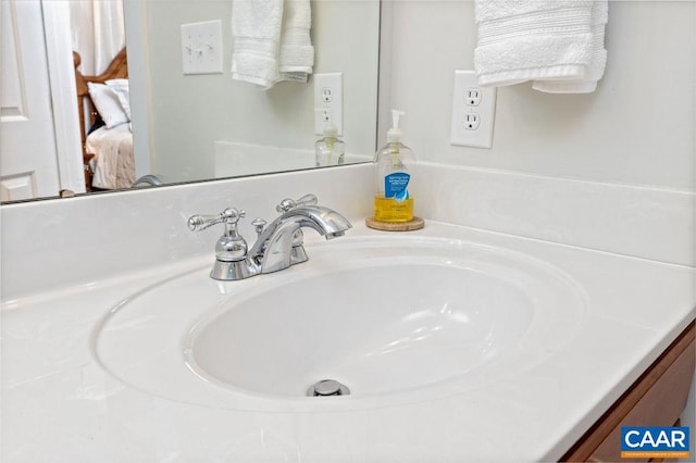 ensuite bathroom with connected bathroom and vanity