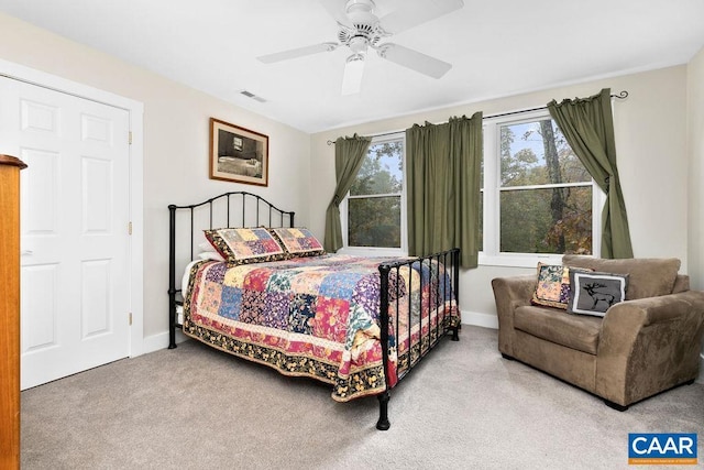 carpeted bedroom featuring baseboards, visible vents, and a ceiling fan