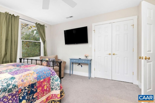 bedroom featuring visible vents, baseboards, a ceiling fan, a closet, and carpet