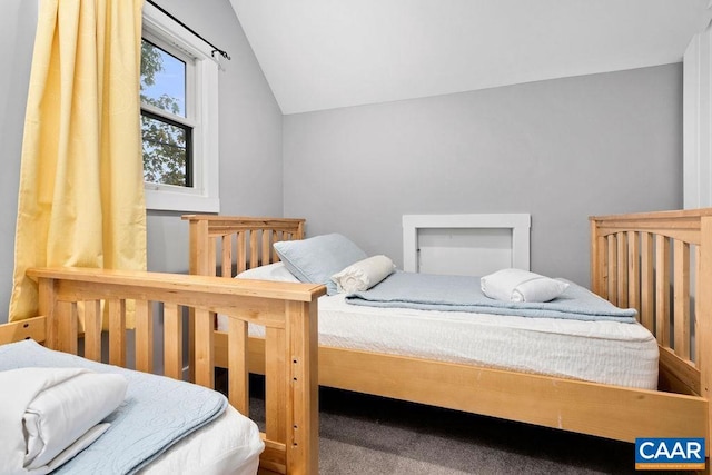 carpeted bedroom featuring lofted ceiling